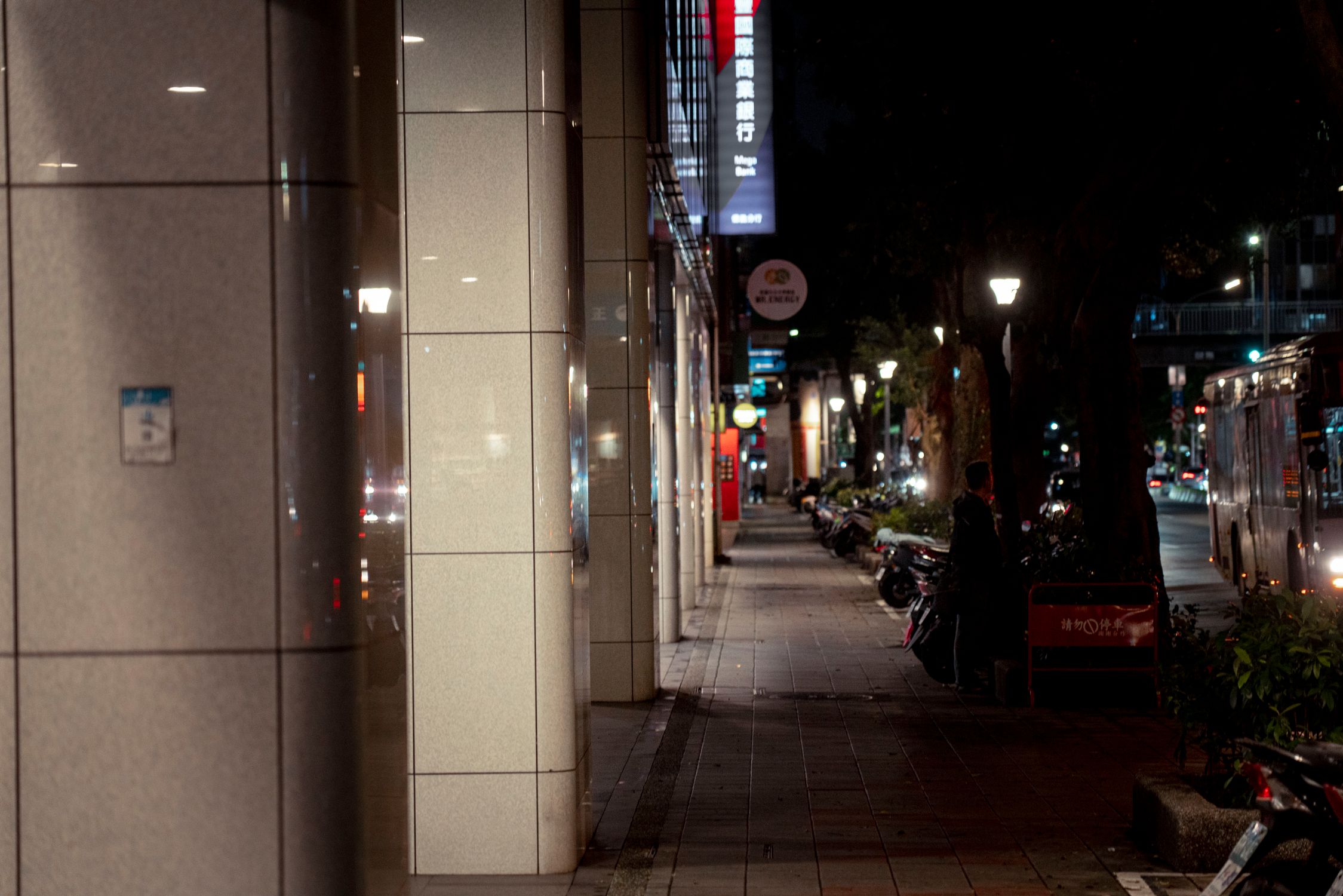 Late evening urban street view in Taipei, Taiwan with dim lights and parked motorcycles