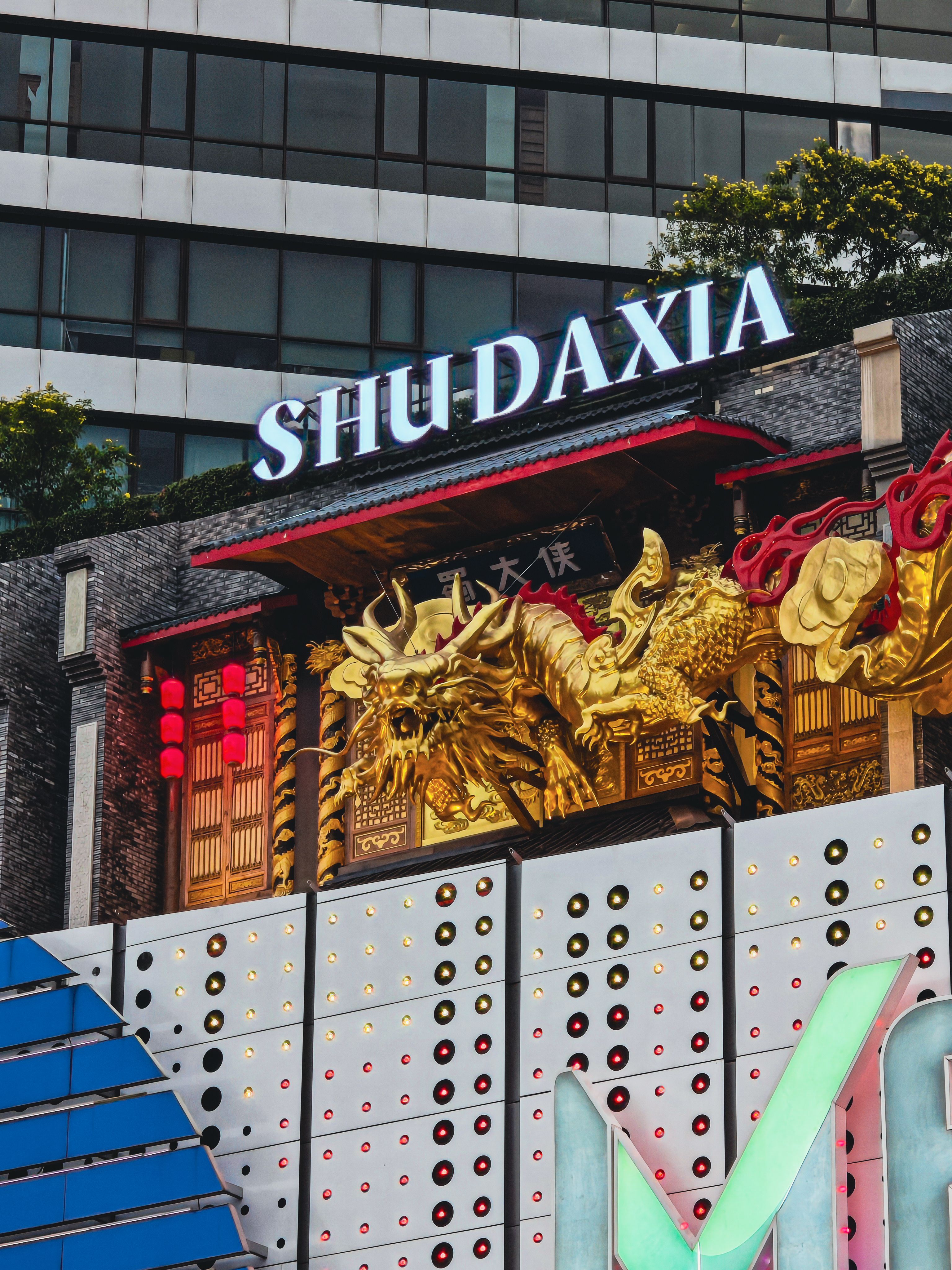 Eye-catching golden dragon facade at Shu Daxia restaurant with vibrant colors and intricate details.