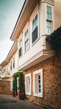 Beautiful colonial architecture with stone walls and large windows, perfect for real estate and travel imagery.