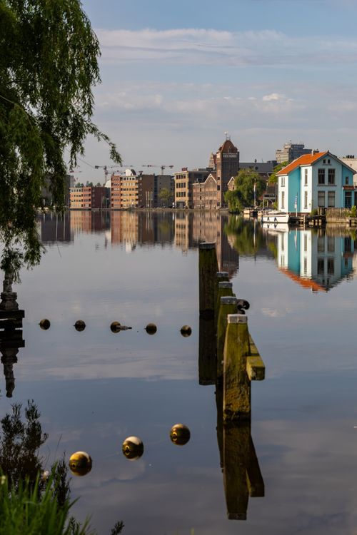 Free Beautiful canal view with urban reflections and a clear sky. Stock Photo