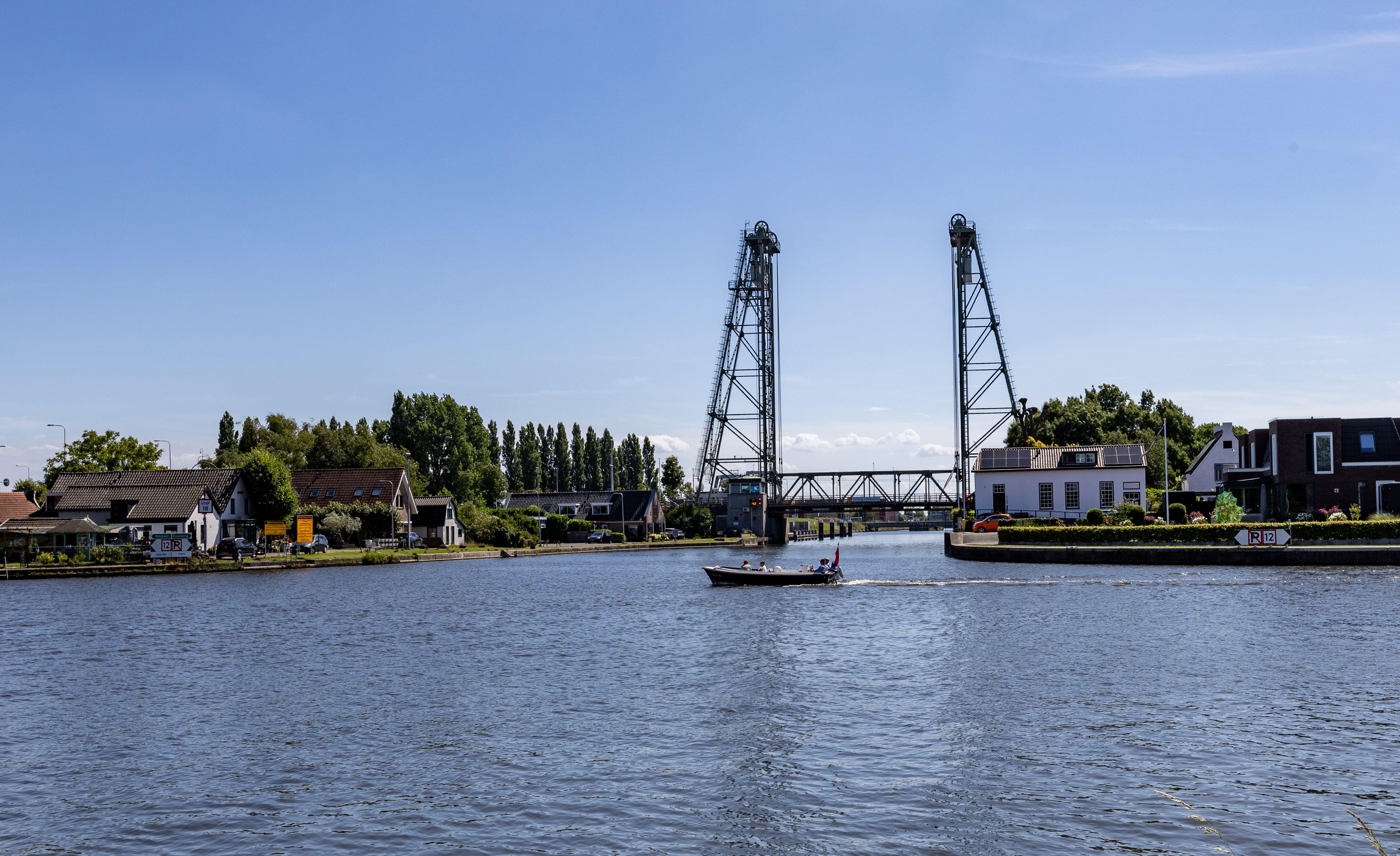 Picturesque River Scene with Drawbridge and Boat · Free Stock Photo