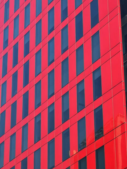 Free Striking red facade of a modern office building in Santiago, Chile under clear skies. Stock Photo