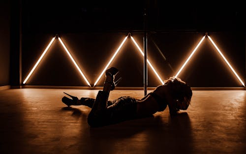 A woman laying on the floor with neon lights