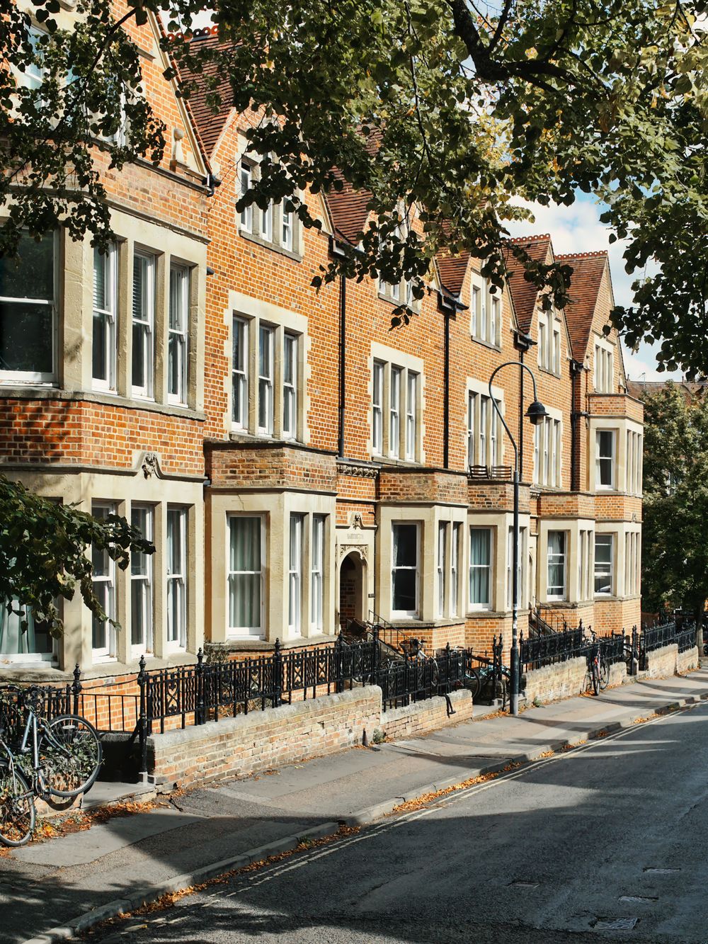 A row of Victorian brick houses on a residential street in Oxford