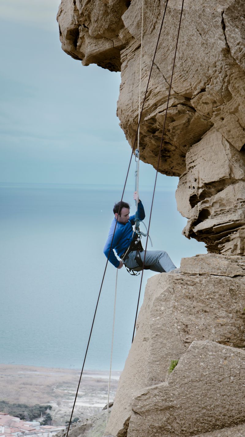 Rock climbing on ocean cliff face