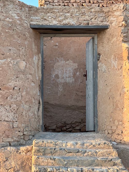 Free A rustic stone doorway leading to an ancient desert ruin. Stock Photo