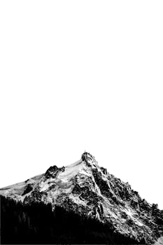 Dramatic black and white image of Chamonix-Mont-Blanc's rugged snow-capped peaks.