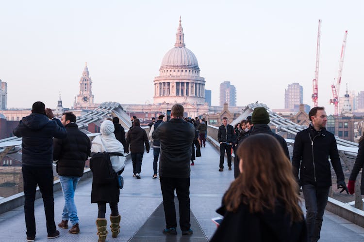 People Walking On Concrete Walkway Near Dome