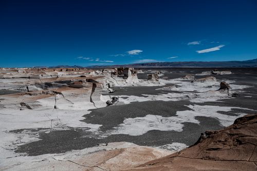 Free A breathtaking view of a desert with distinctive rock formations under a clear blue sky. Stock Photo