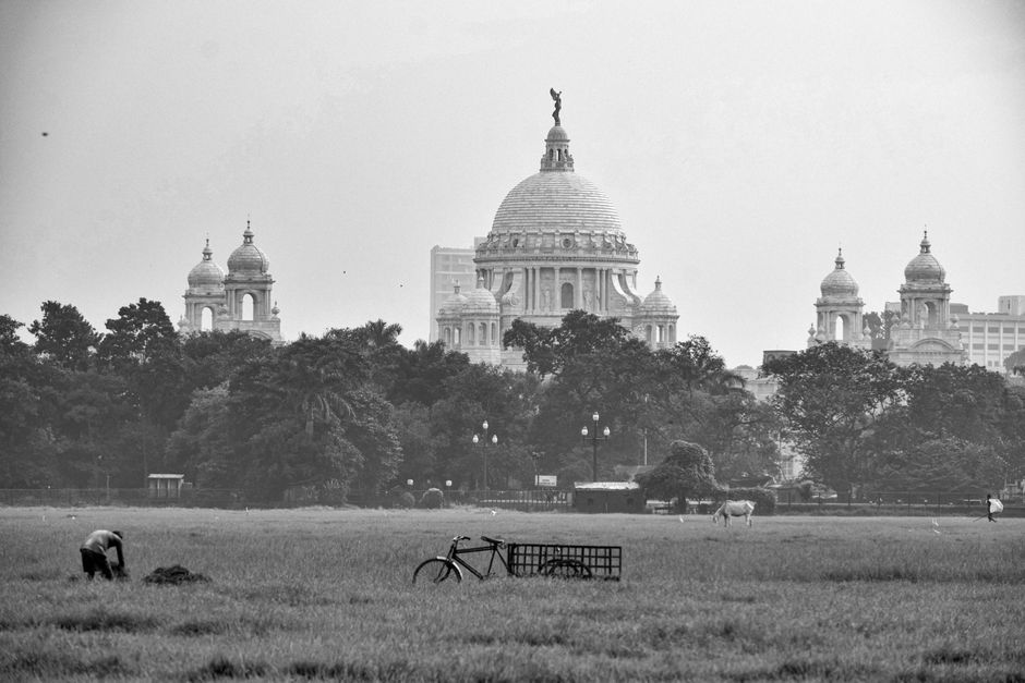 Black and white view of the Victoria Memorial with a rural foreground in Kolkata, India.