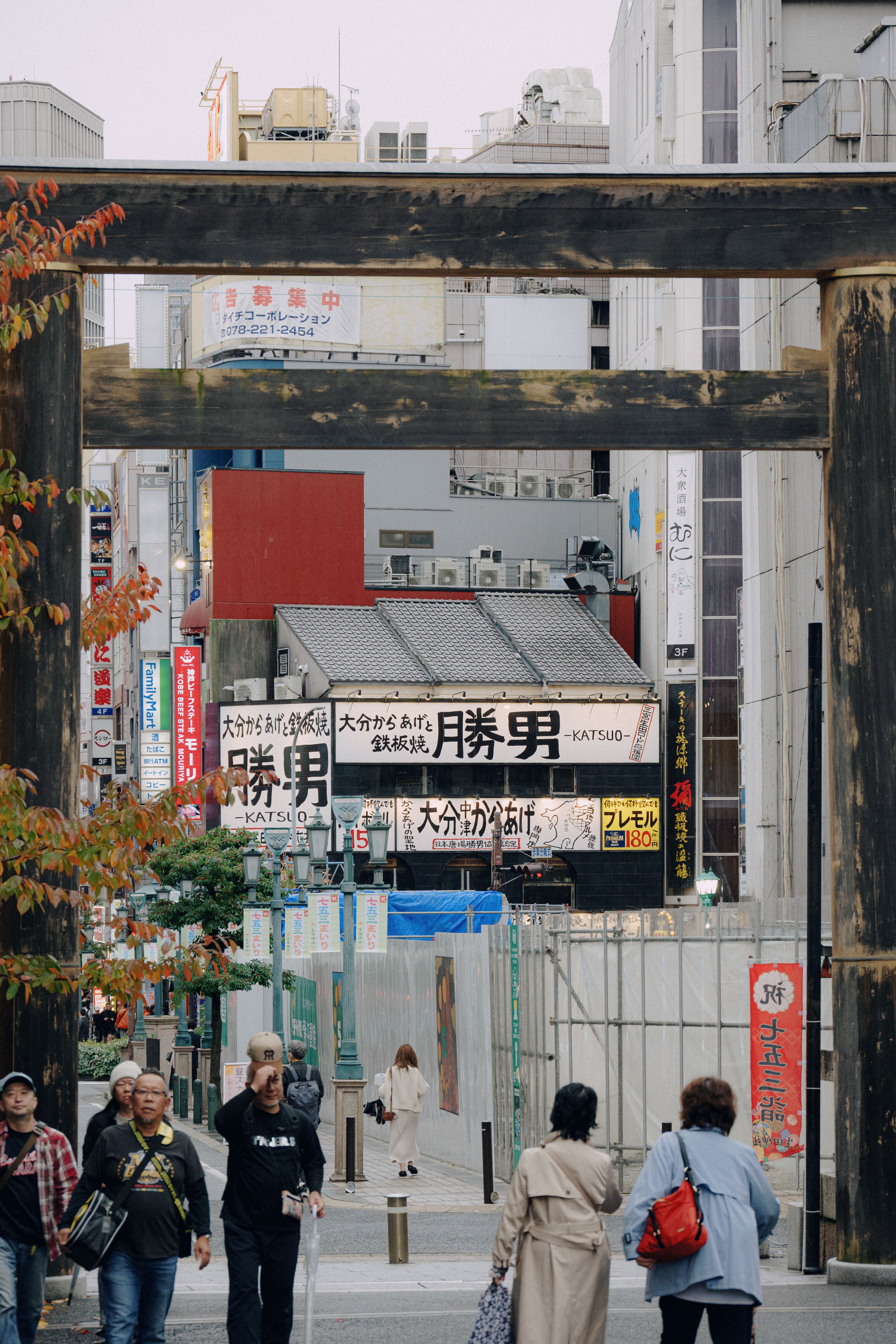 Bustling Urban Street in Tokyo with Torii Gate · Free Stock Photo