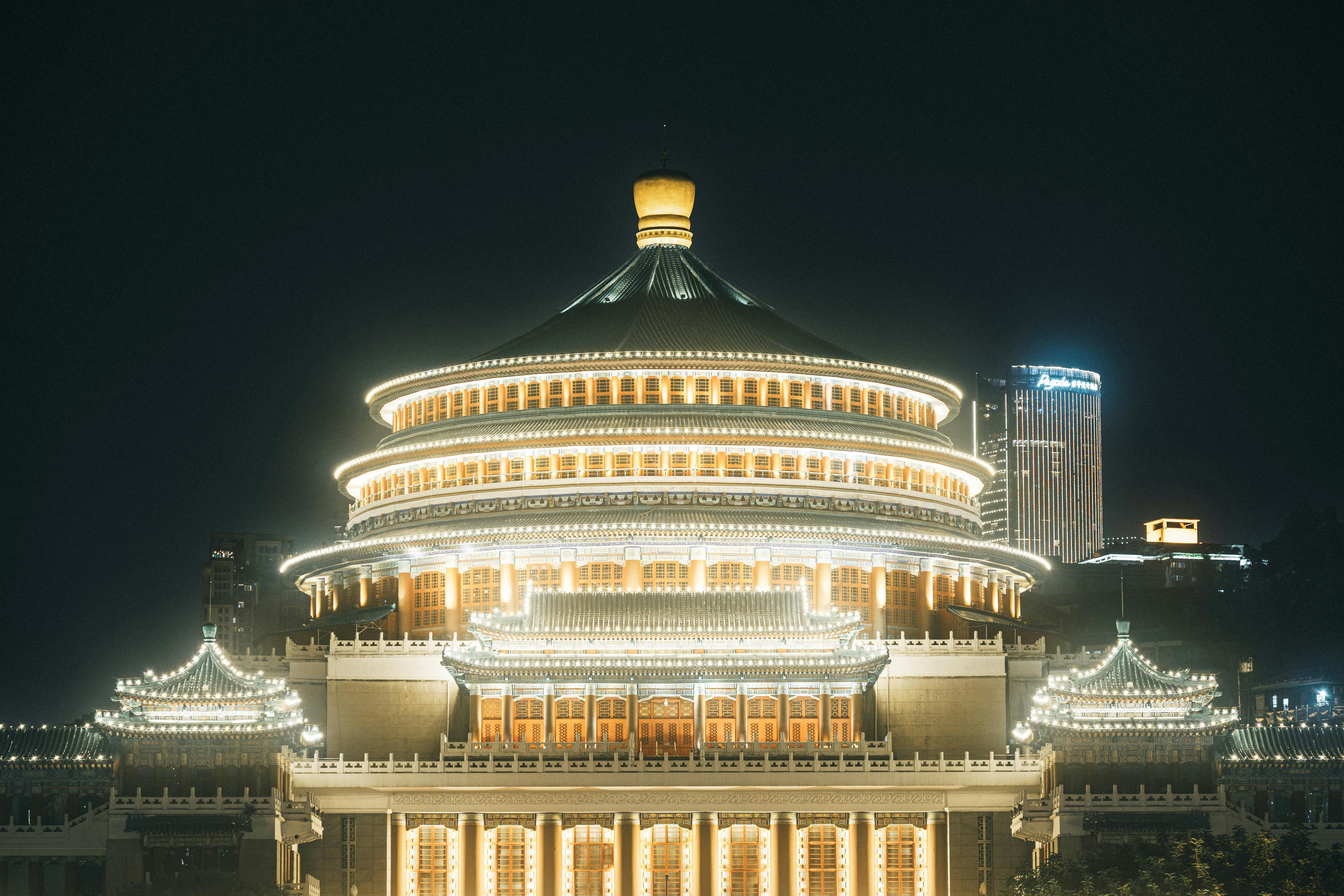 Stunning night shot of a beautifully lit Chinese pavilion, showcasing intricate architecture.