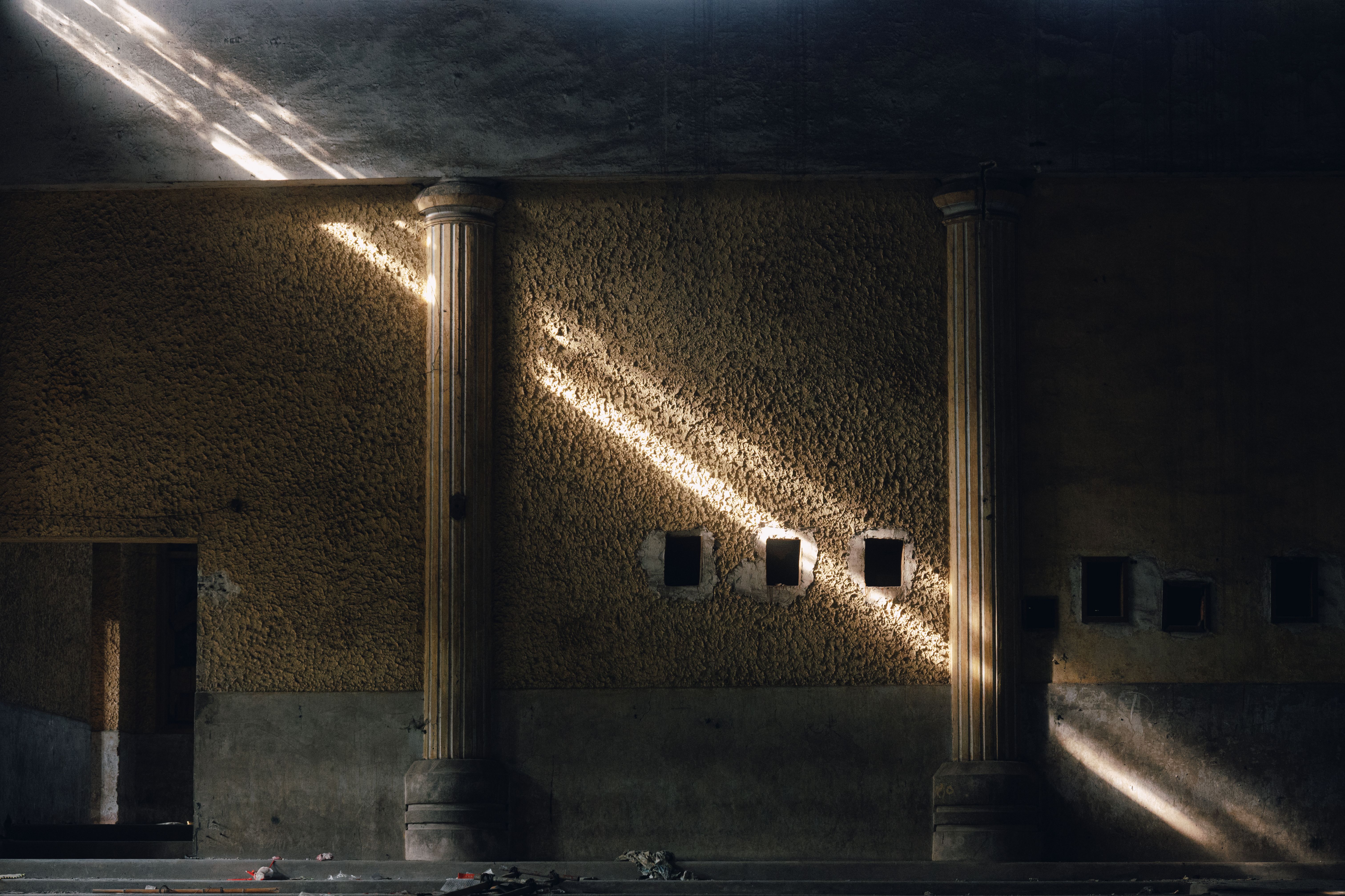 Sunlight Streaming Through Abandoned Building Wall · Free Stock Photo