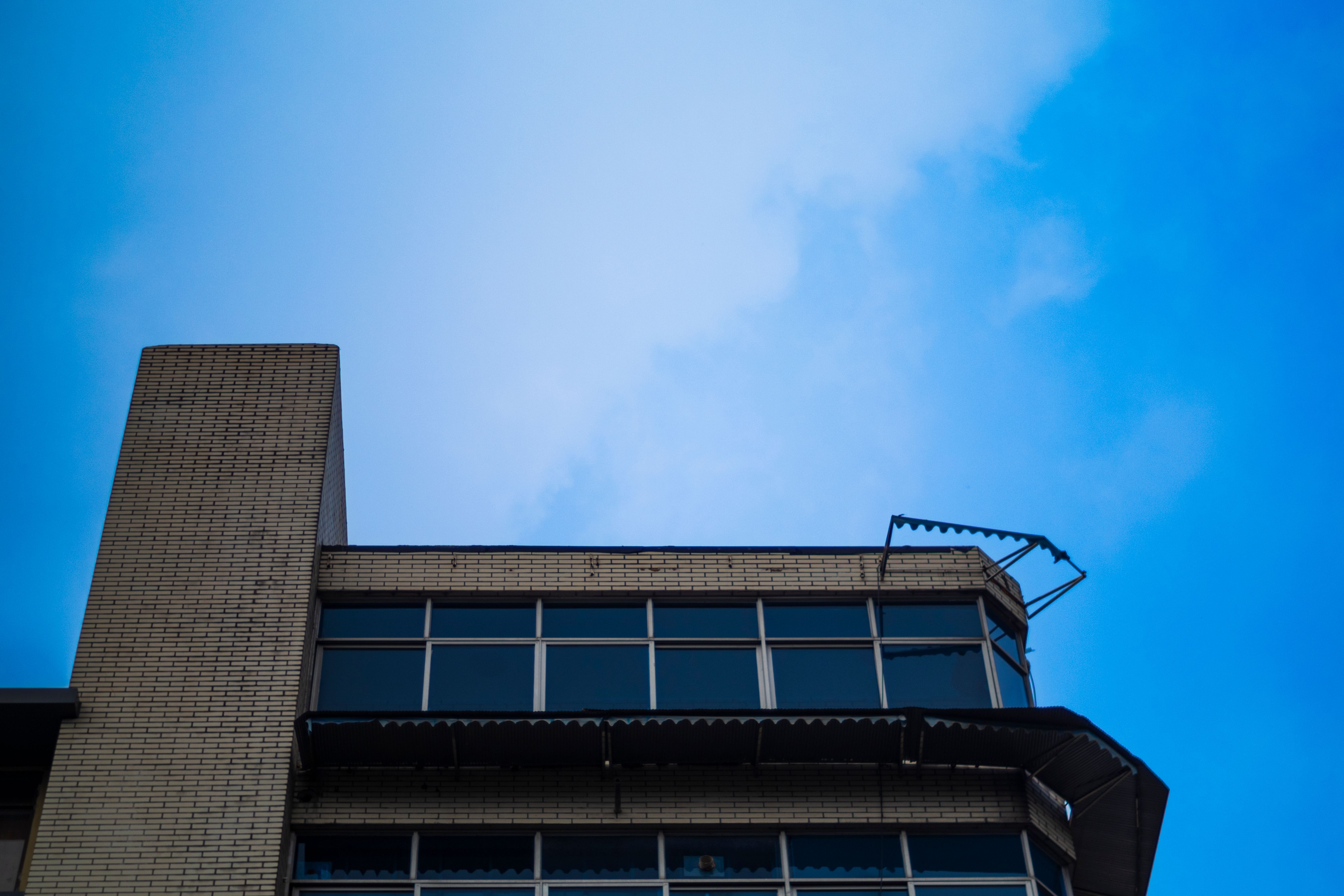 Modern Building Against a Clear Blue Sky · Free Stock Photo