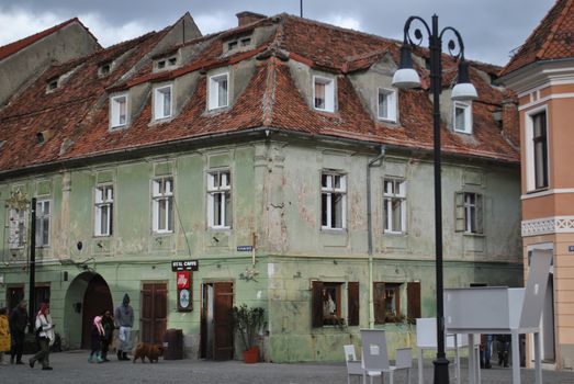 Charming European street featuring an old building with worn facades, adding a rustic charm to the urban landscape.
