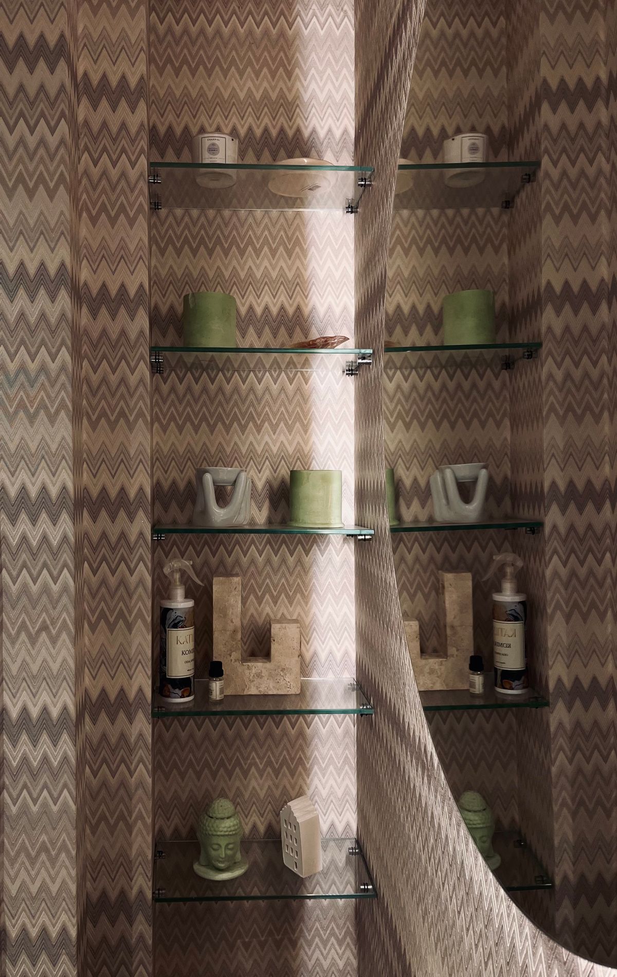 Stylish bathroom floating shelves with zigzag wallpaper and minimalist decor pieces
