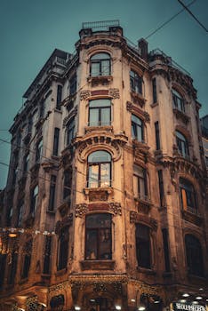 A classic vintage architecture building in Istanbul, Türkiye, captured at night with warm lighting.