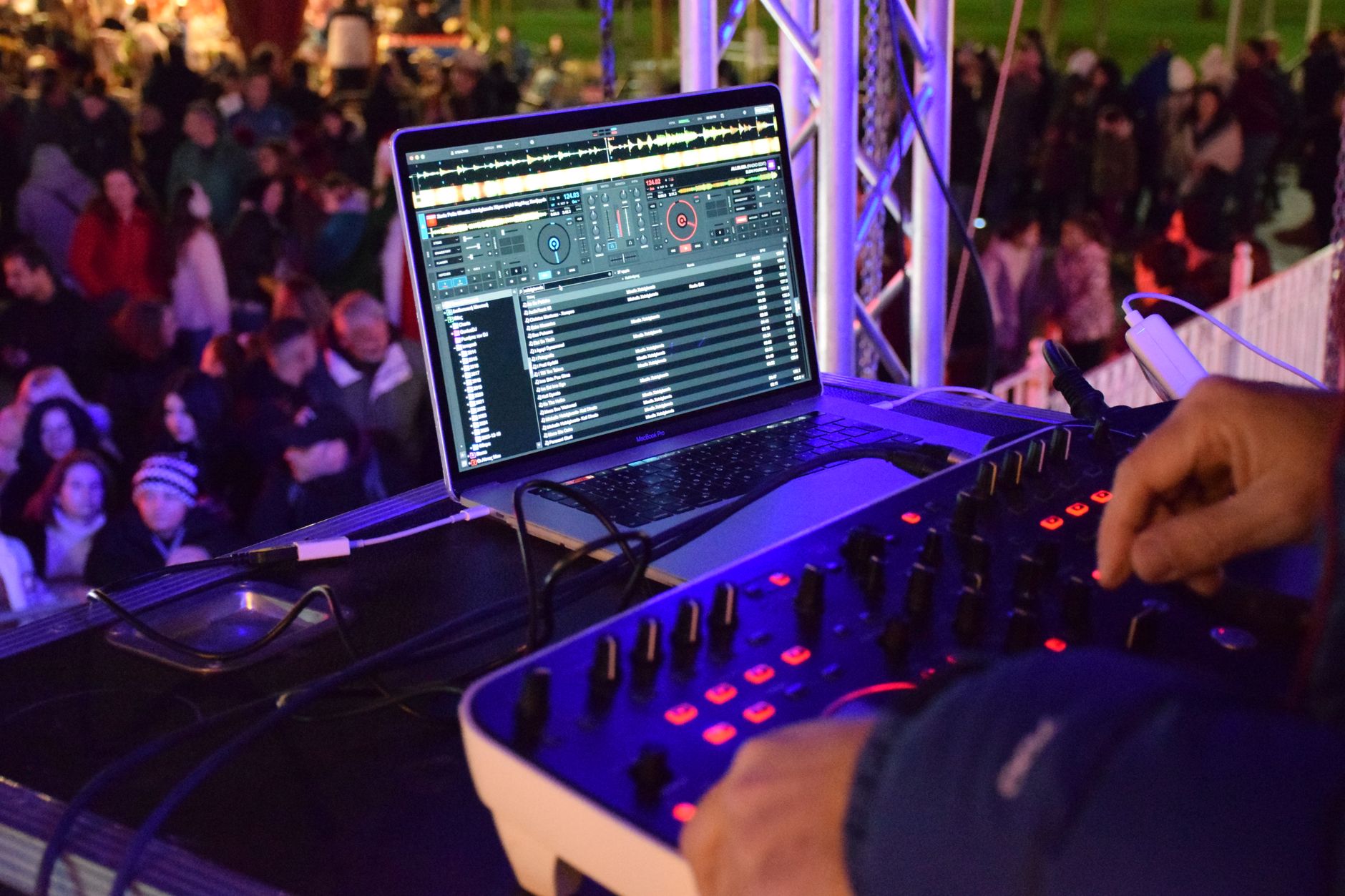 Vibrant outdoor night DJ performance with an engaged crowd and professional equipment.