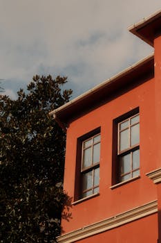 Elegant red building facade in Istanbul under warm autumn light.