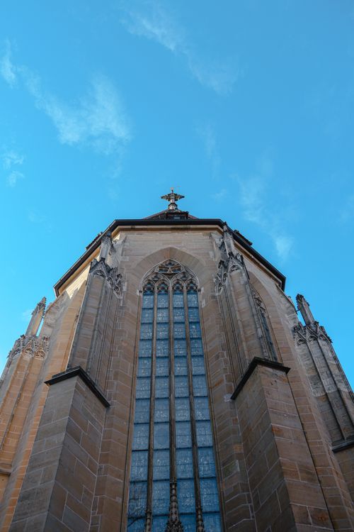 Free Gothic architecture of St. James Church against a clear blue sky in Rothenburg ob der Tauber. Stock Photo