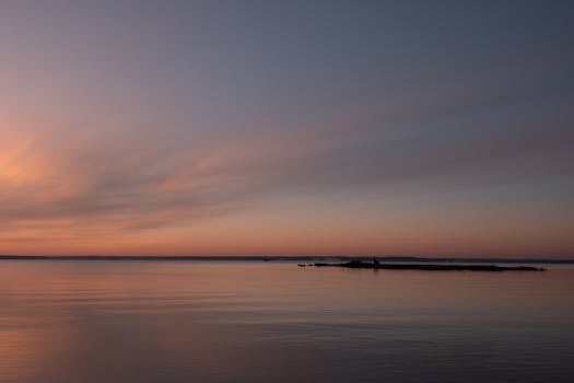 Capture of a tranquil winter sunrise at Cove Island Park, Stamford with a pink sky and calm waters.