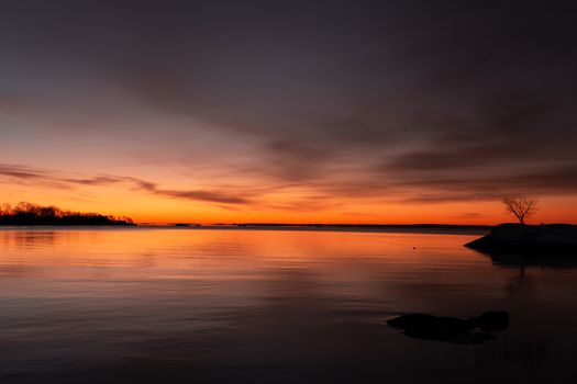 A breathtaking winter sunrise over calm waters at Cove Island Park, Stamford, Connecticut.