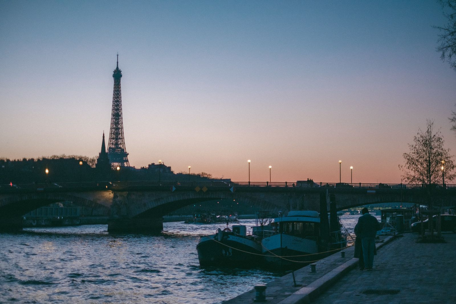 Paris Seine river at dusk with Eiffel Tower lit up
