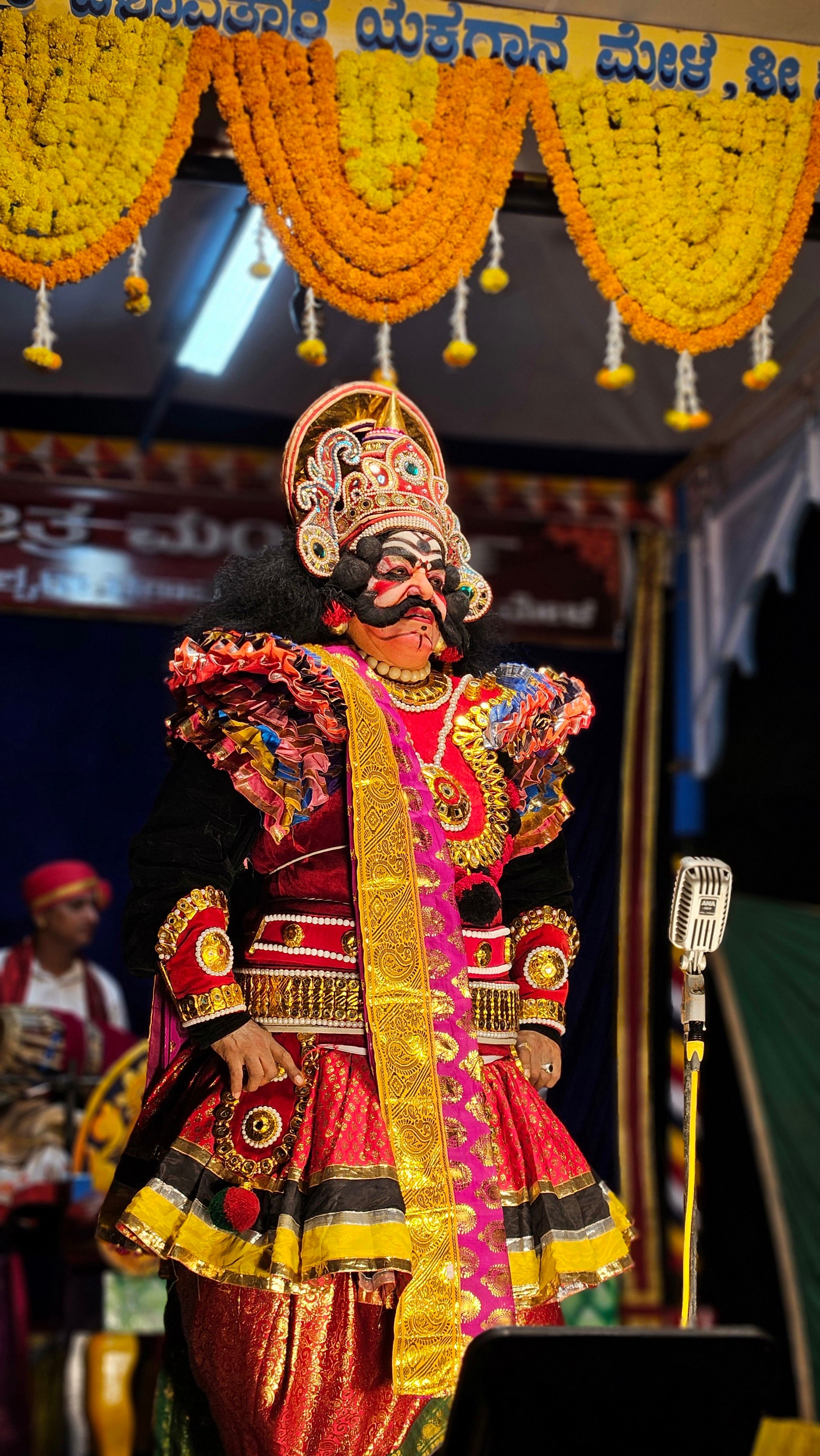 Spectacular Yakshagana performer in vibrant costume during a traditional cultural event in Udupi, India.