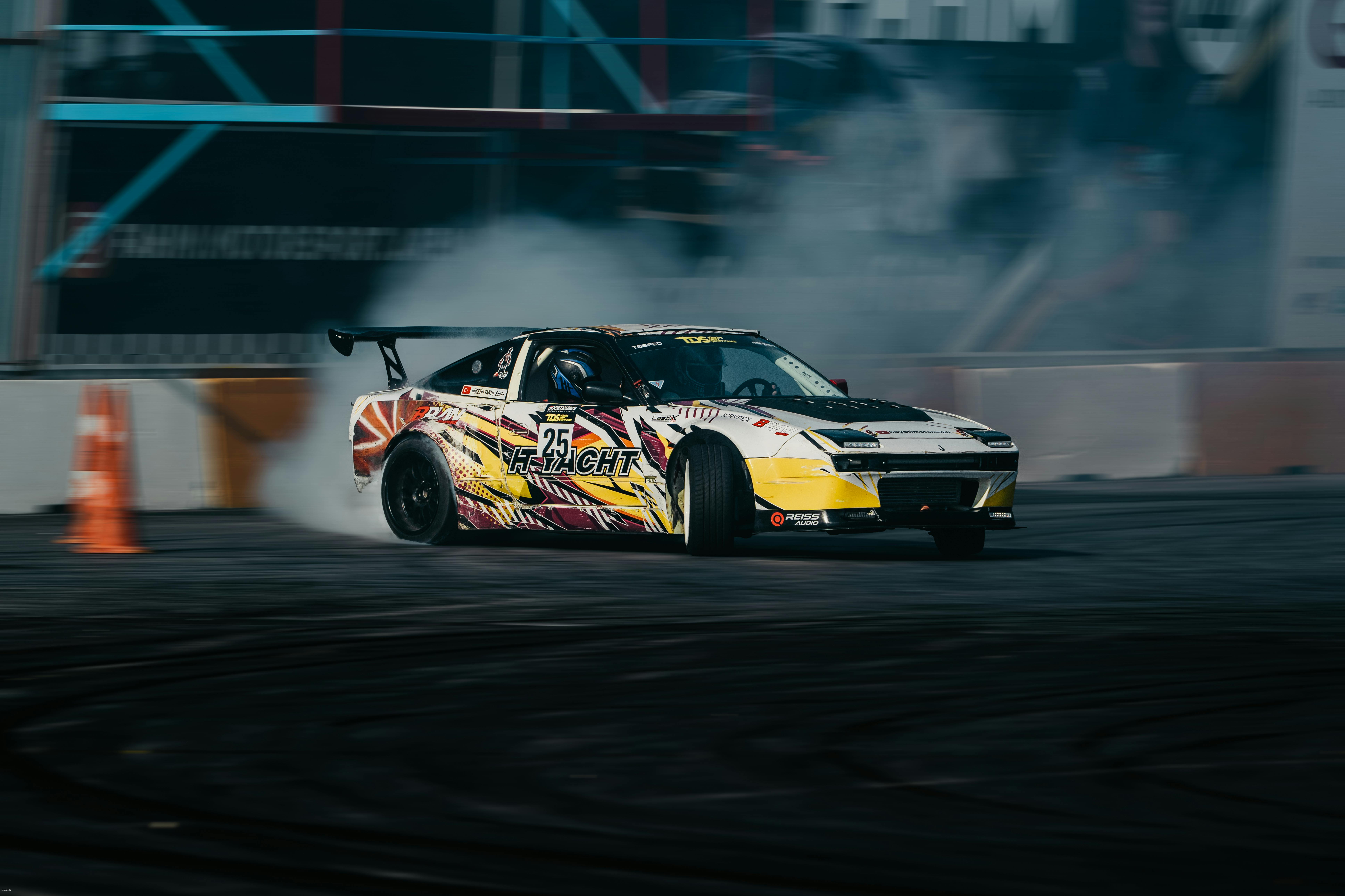 Exciting drift racing car performing on track with smoke effects, vibrant colors, and high speed.