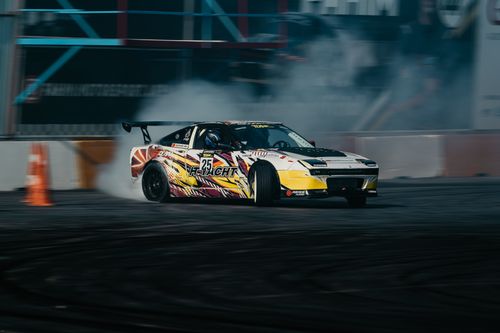 Free Exciting drift racing car performing on track with smoke effects, vibrant colors, and high speed. Stock Photo