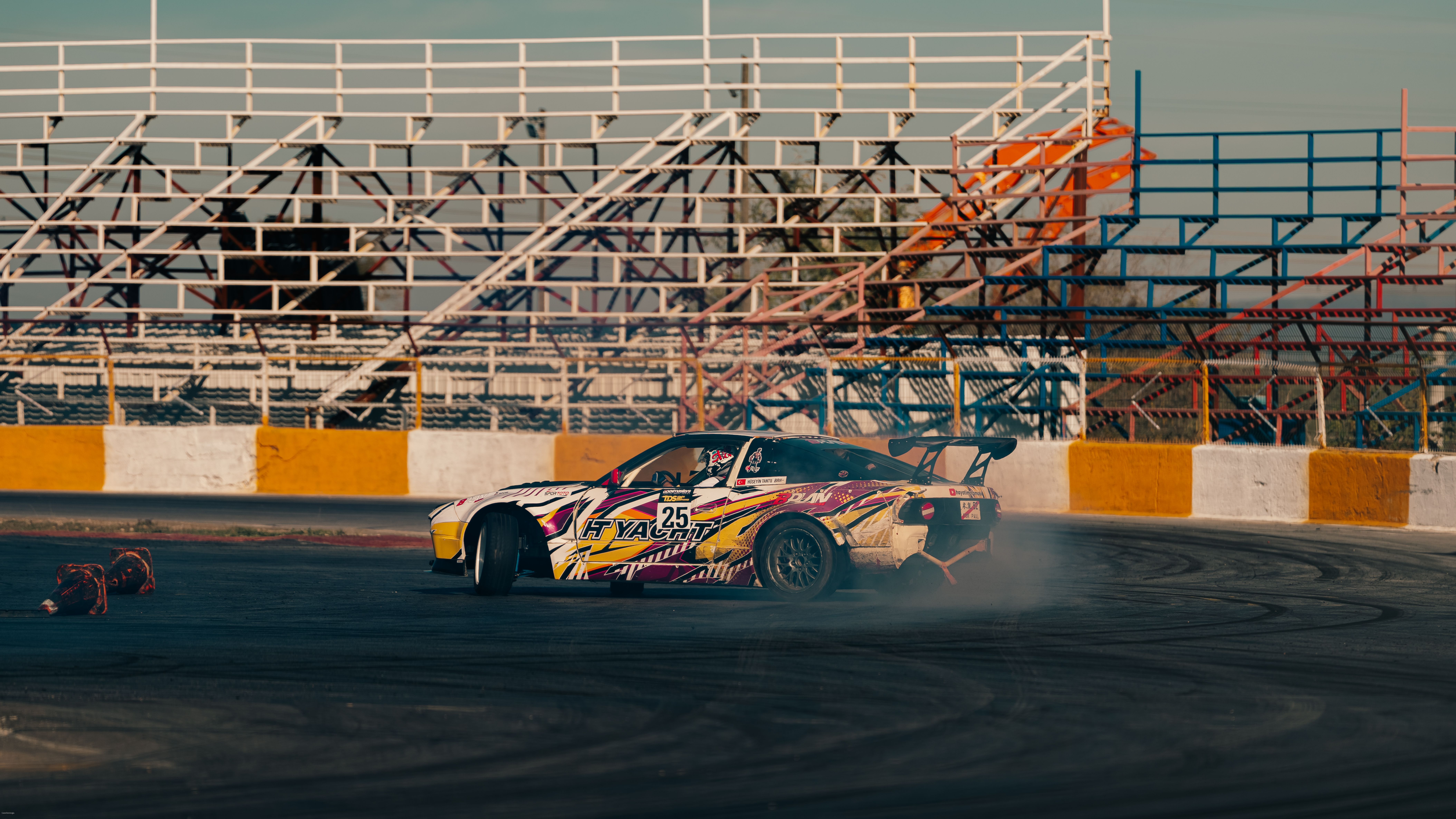 Colorful drift car leaving smoke on a racing track