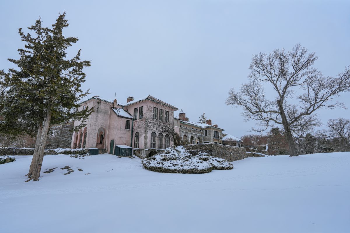 Historic Quebec manor overlooking snowy river landscape