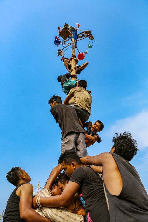Free Men celebrate Indonesian independence with the traditional climbing game Panjat Pinang. Stock Photo