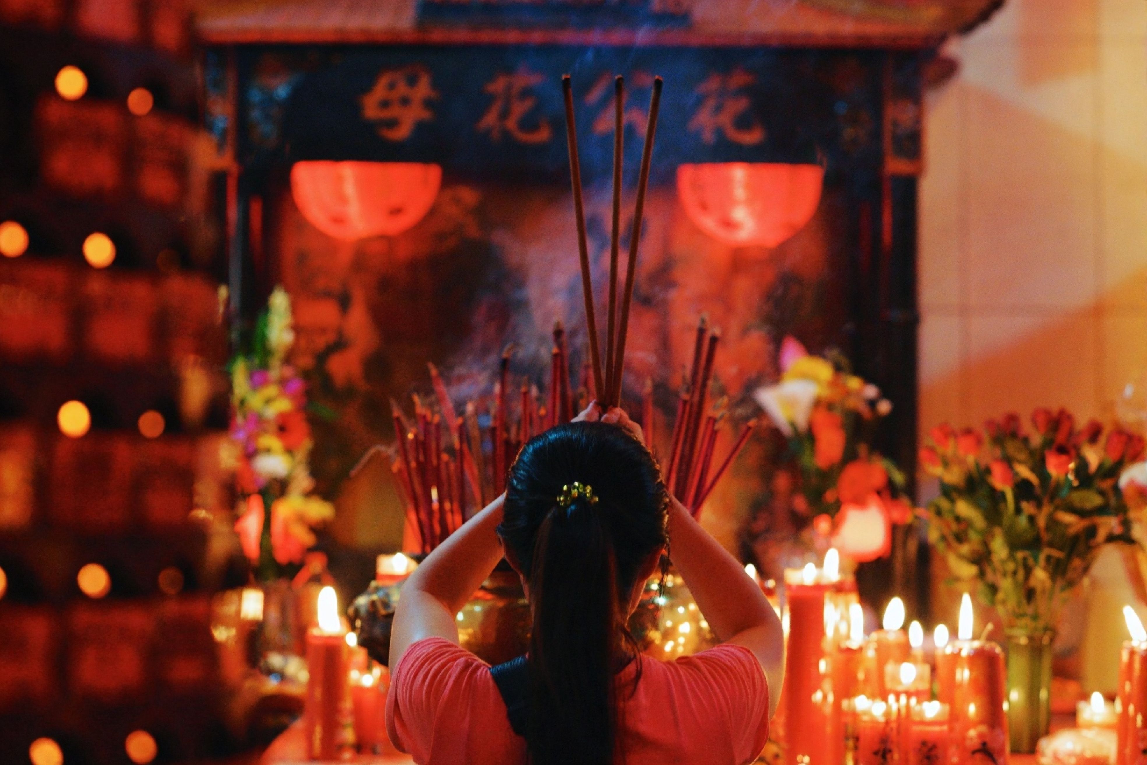 Woman Performing Ritual in Vibrant Temple Setting · Free Stock Photo