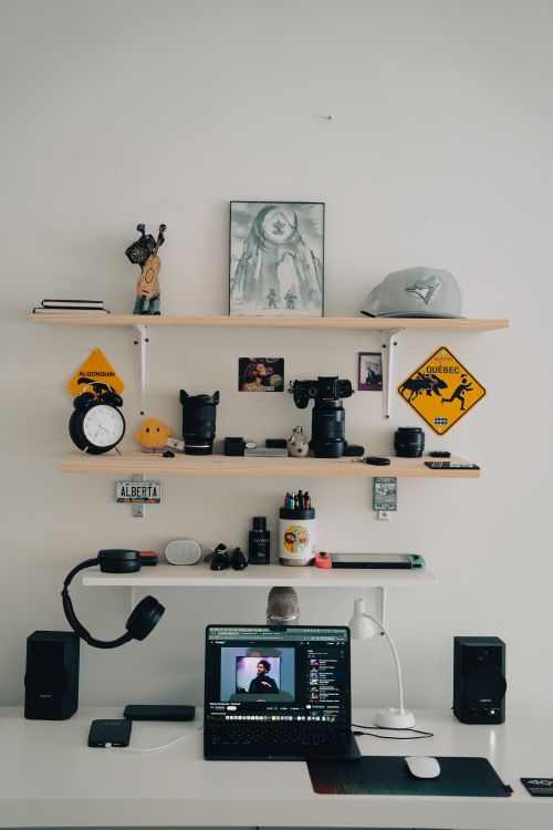 Free A stylish and organized home office desk with creative decorative items on shelves. Stock Photo