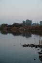 Tranquil Urban Lake Reflecting City Skyline