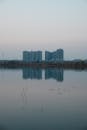 High-rise Buildings Reflecting on a Calm Lake at Dusk