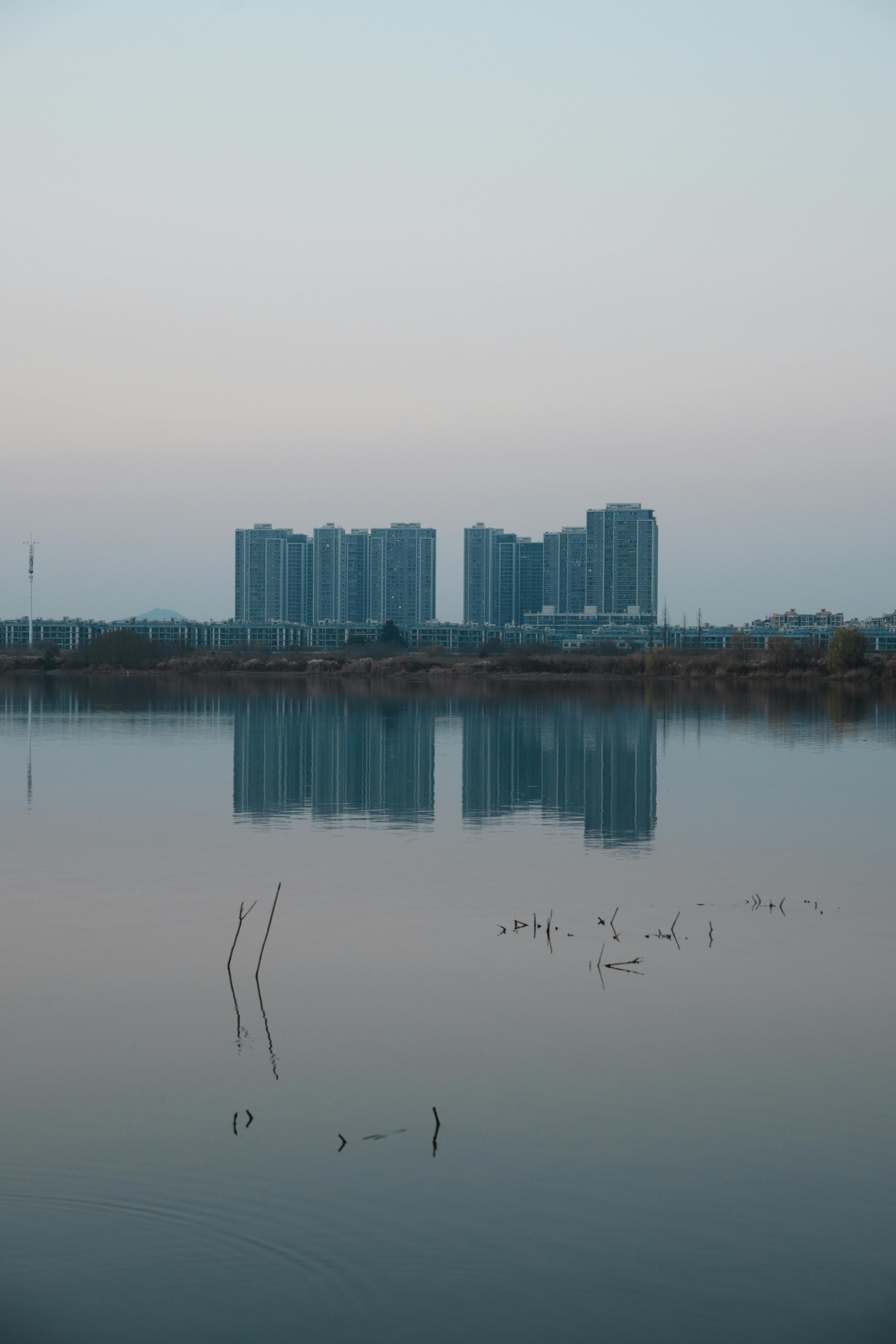 High-rise Buildings Reflecting on a Calm Lake at Dusk