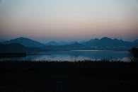 Serene Lakeside Dusk with Mountain Silhouette
