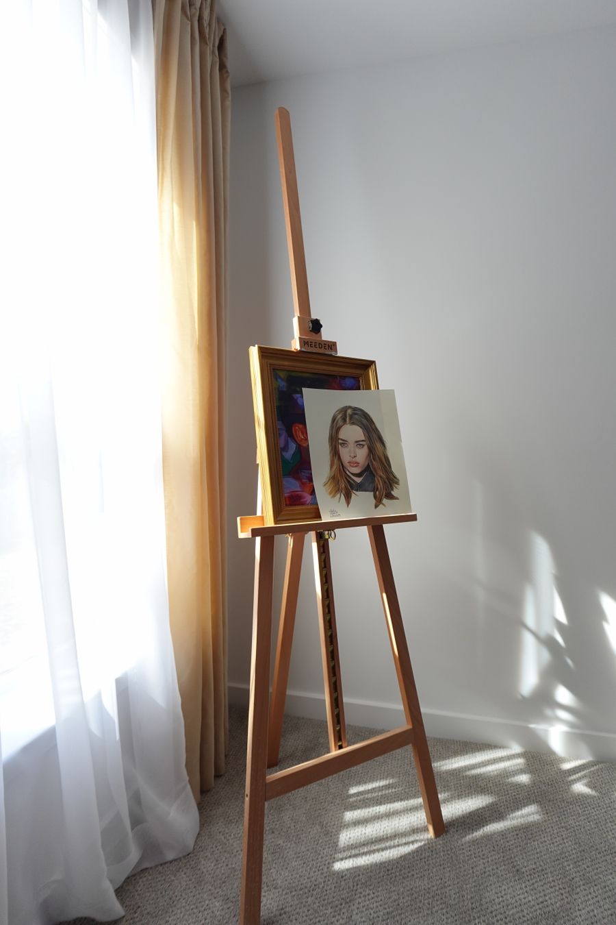 Portrait painting on an easel in sunlight