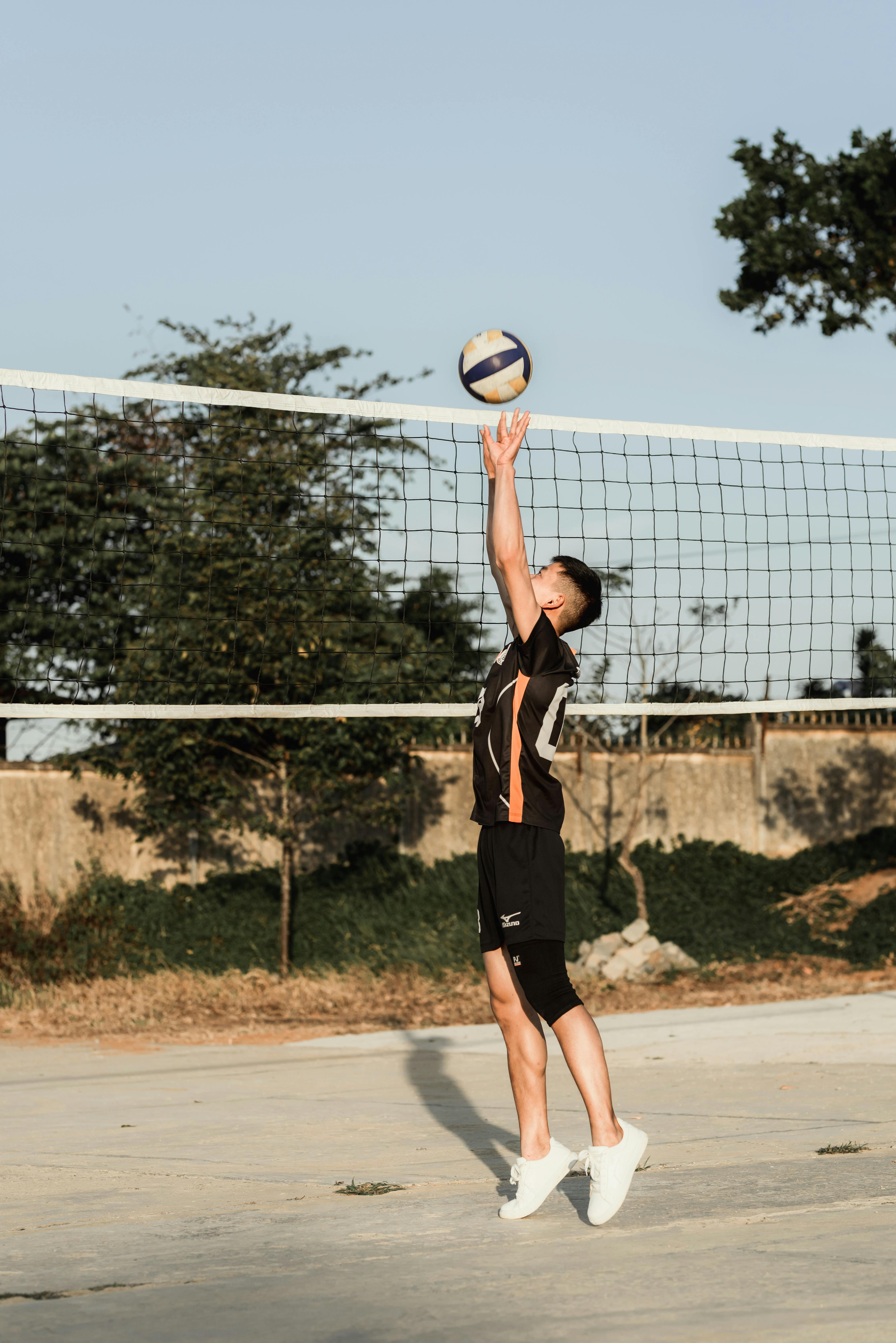 photo of man playing volleyball