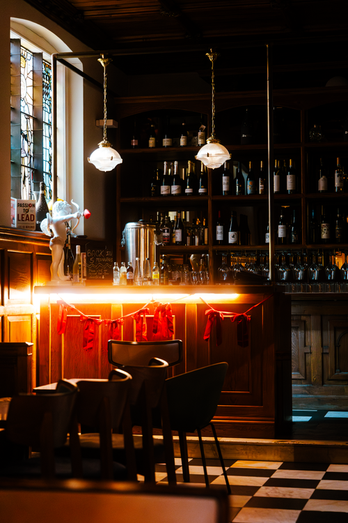 Free Moody bar interior in London featuring warm lighting and vintage decor. Stock Photo
