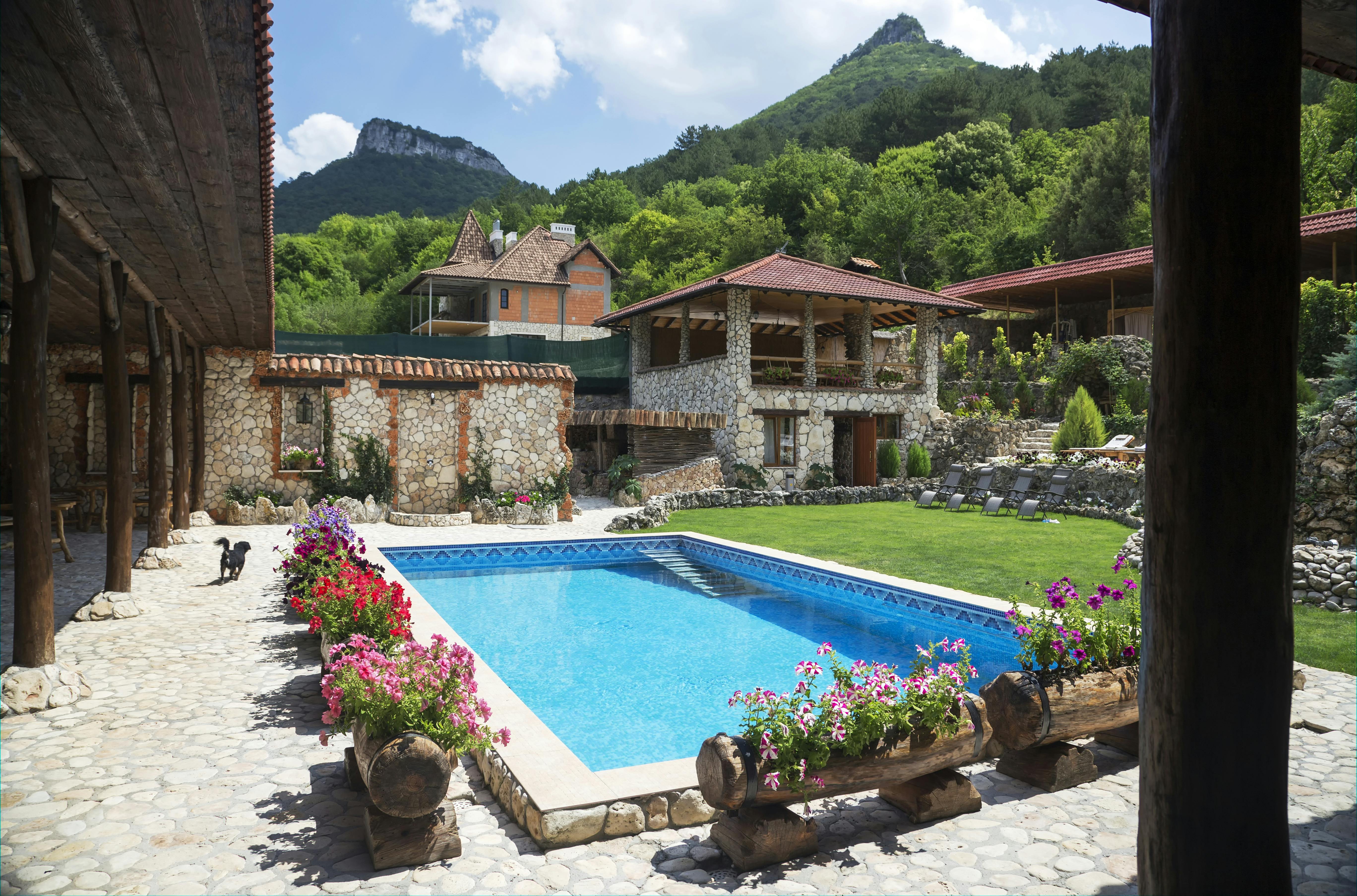Charming stone villa with pool set in scenic mountain landscape.