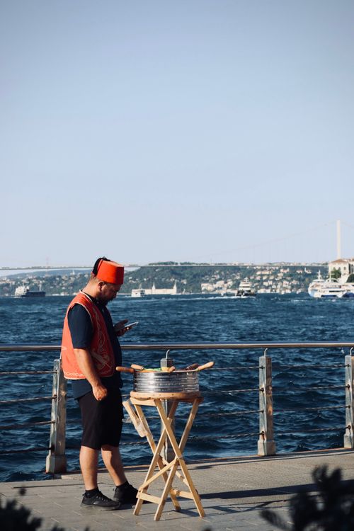 Free Street vendor in traditional dress by the Bosphorus, Istanbul, selling food. Stock Photo