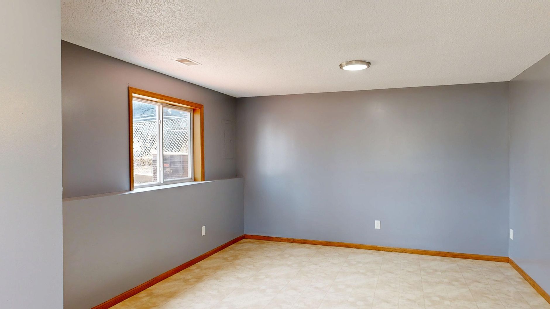 Bright living room with warm white walls and natural light photographed for a real estate listing