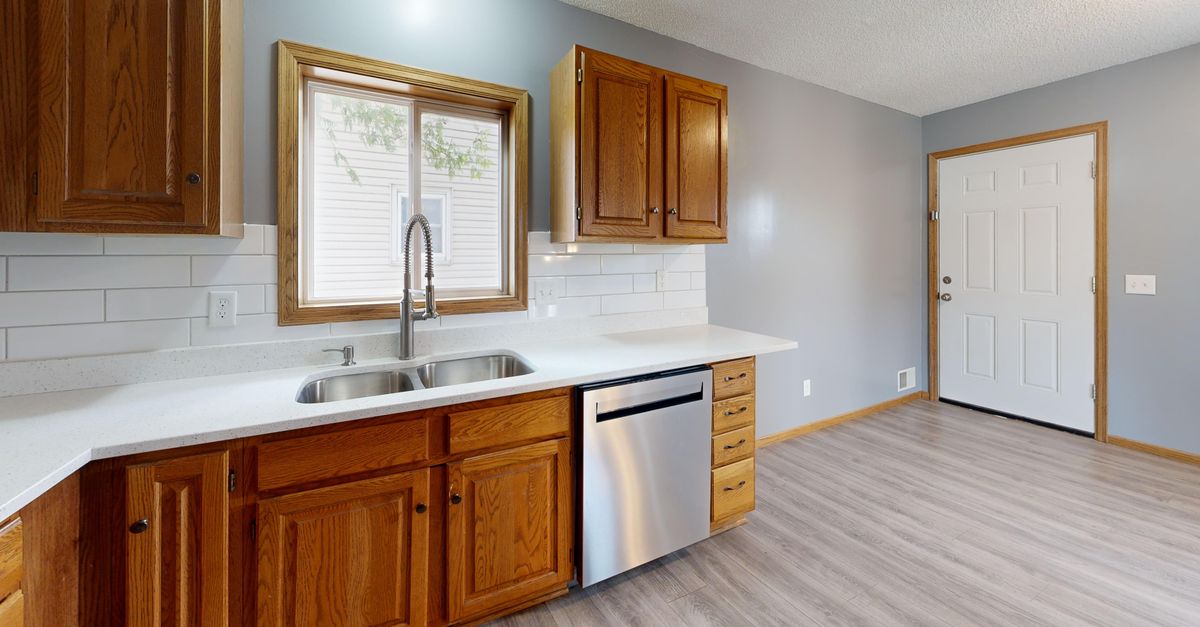 Spacious kitchen with oak cabinets, stainless steel appliances, and natural lighting.