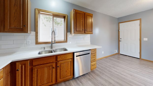 Spacious kitchen with oak cabinets, stainless steel appliances, and natural lighting.
