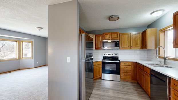Spacious kitchen featuring stainless steel appliances and wooden cabinetry.