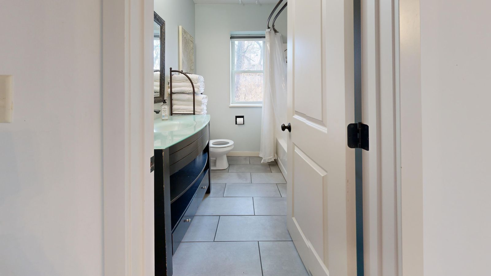 Modern bathroom with tiled floor and walls