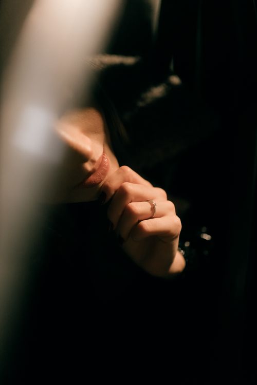 Free Artistic photo of a woman partially obscured in shadow, creating a mysterious mood. Stock Photo